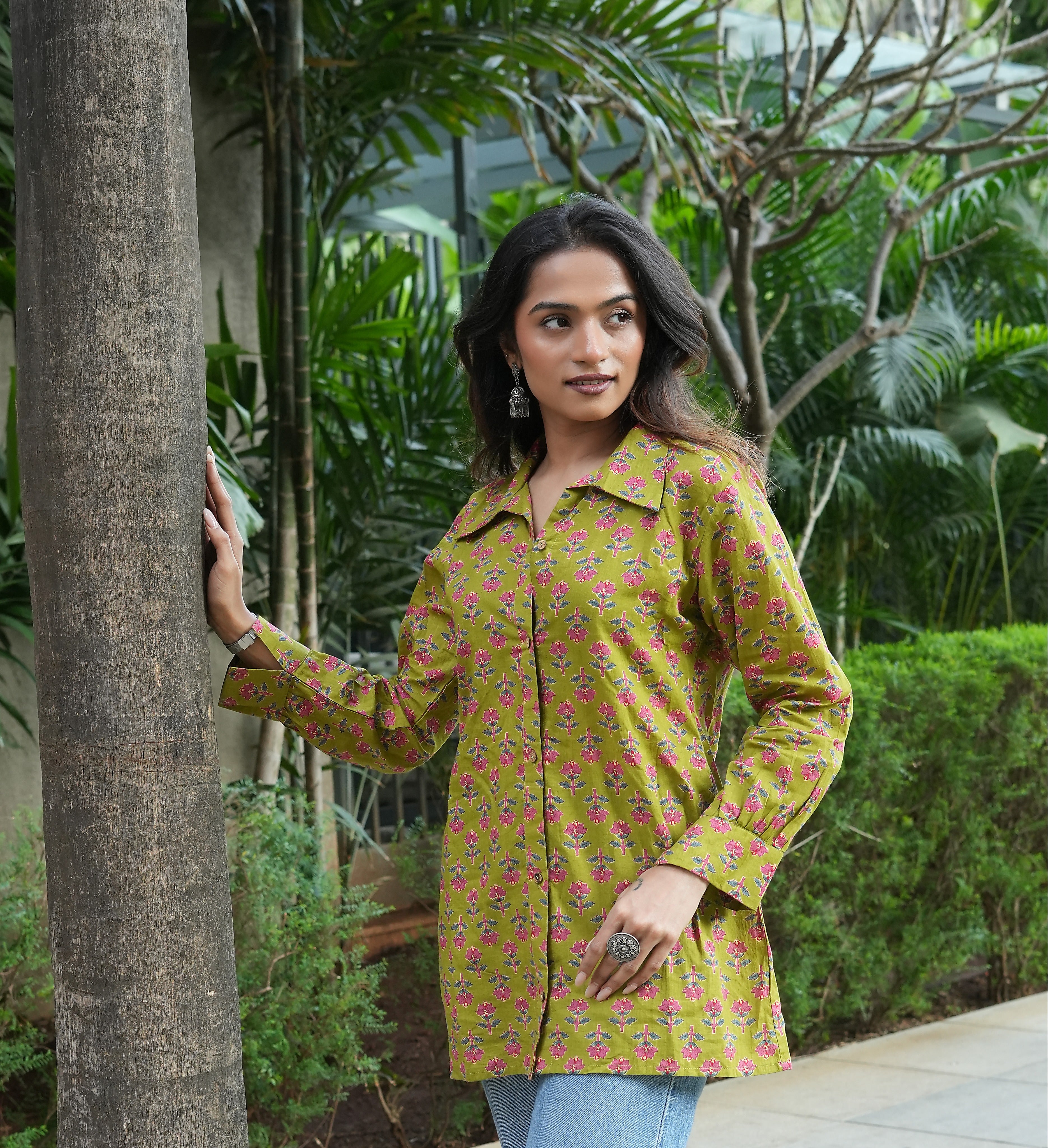 Woman wearing a Phoolwari shirt standing in a garden