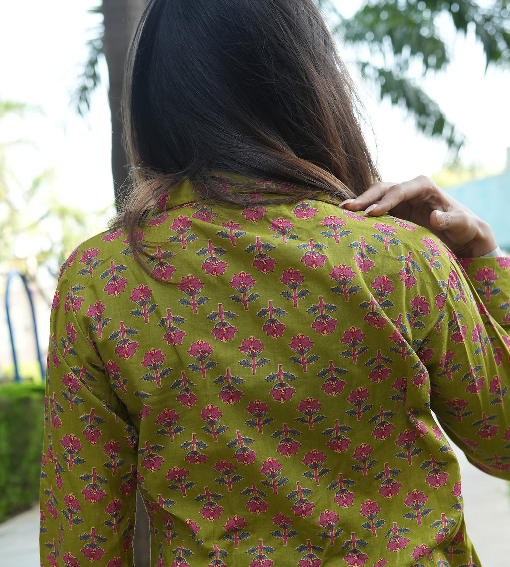 Person wearing a Phoolwari shirt patterned shirt with trees in the background