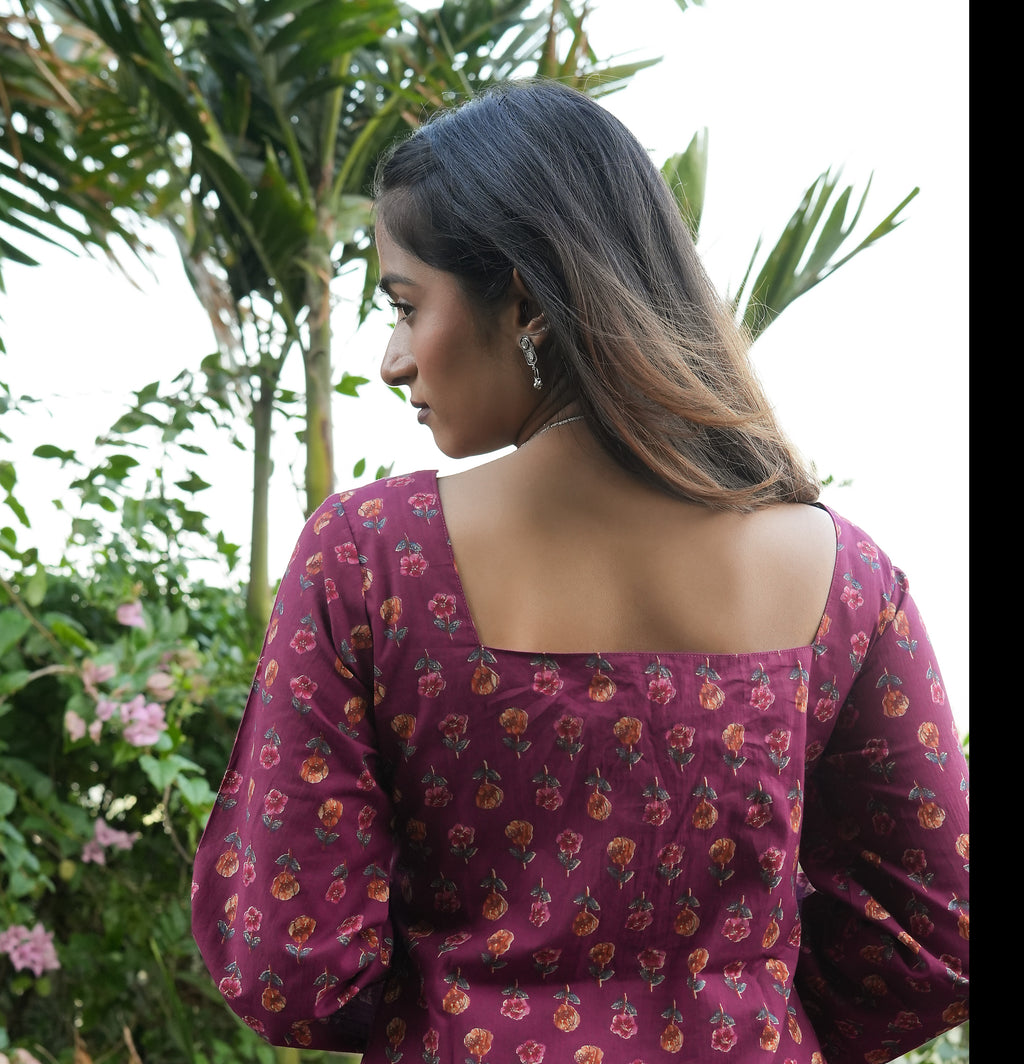 Woman wearing a Wine blossom kurti with a blurred natural background