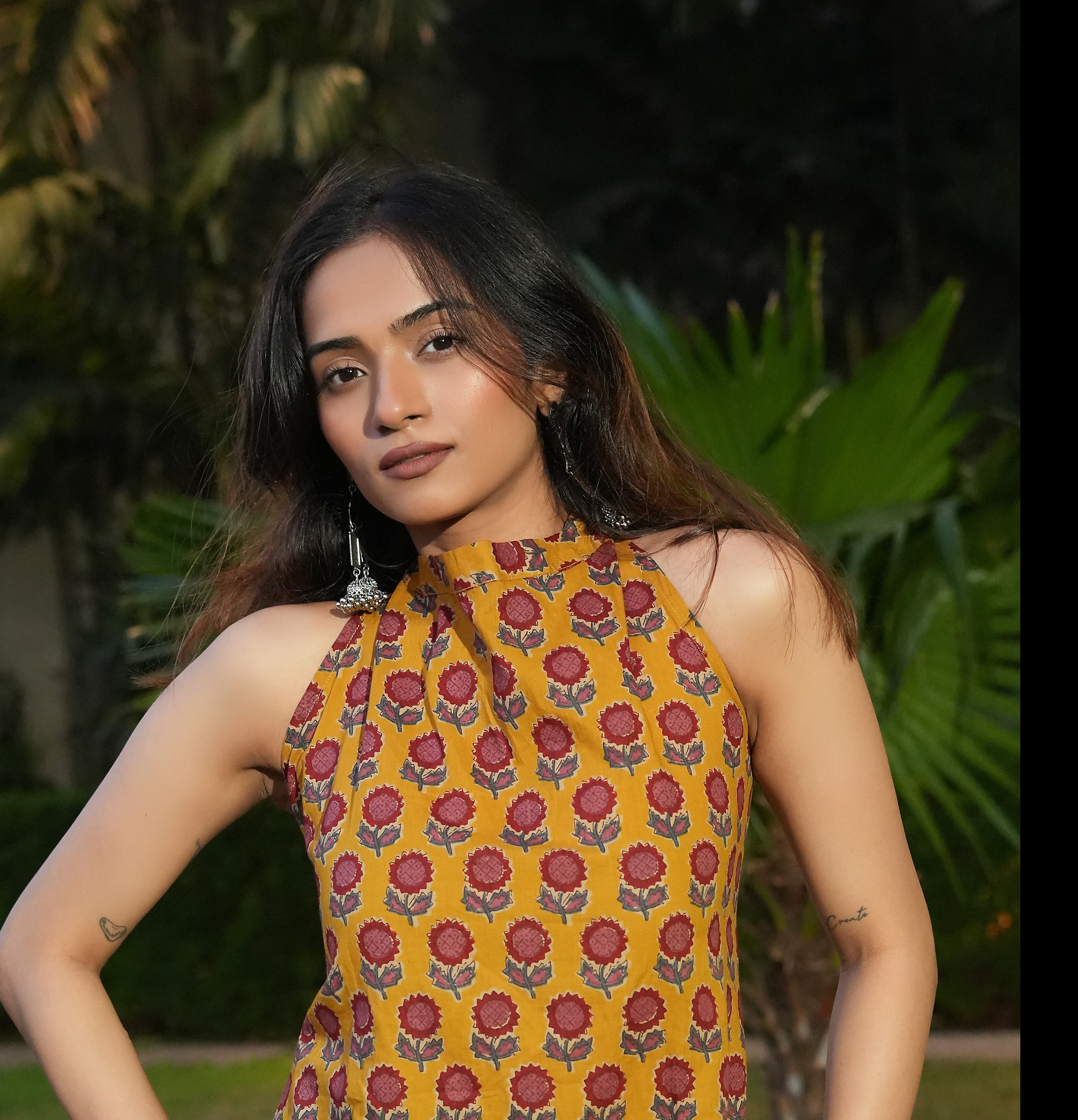 Woman wearing a Marigold Kurti with greenery in the background