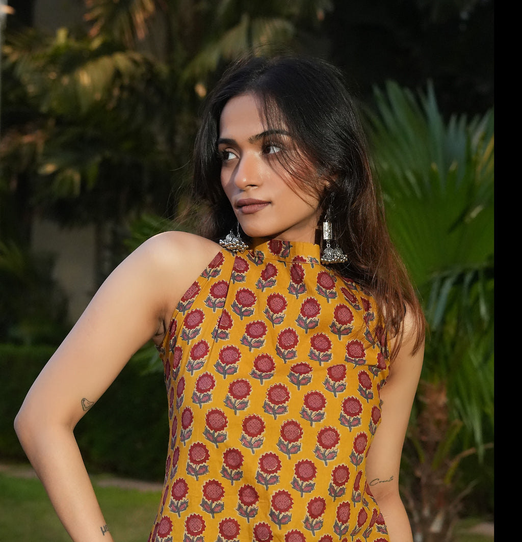 Woman wearing a Marigold Kurti l dress with greenery in the background