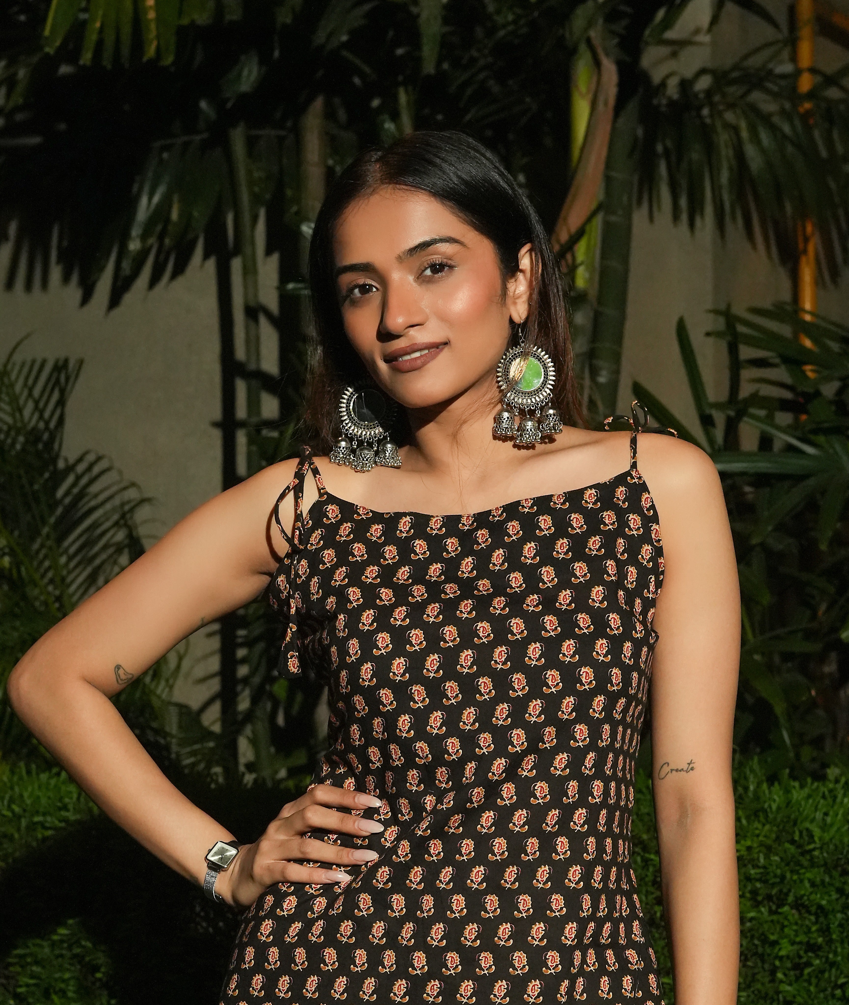 Woman wearing a Kaala tie-up Kurti with large earrings in an outdoor setting